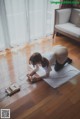 A woman laying on the floor playing a video game.